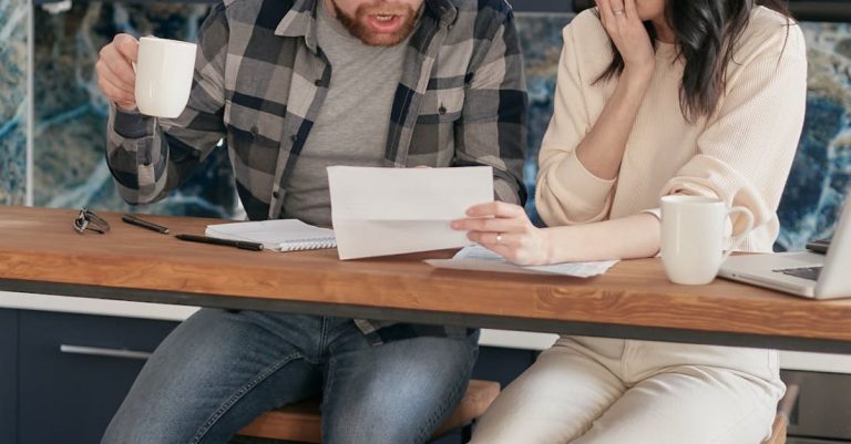 Compost Problems - A Couple Sitting Near the Wooden Table while Looking at the Document in Shocked Emotion