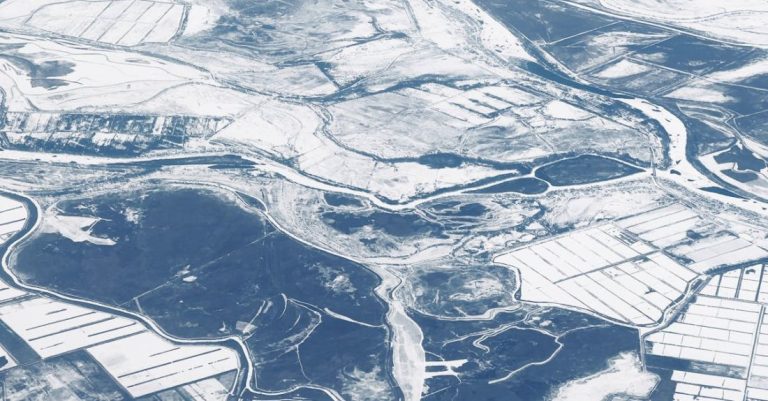 Winter Composting - An aerial view of a river and snow covered land