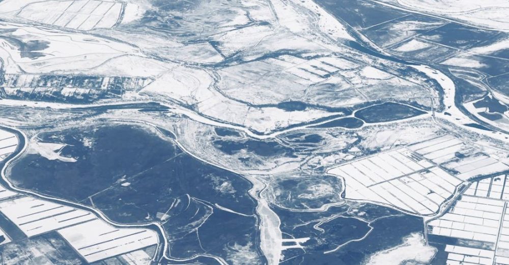 Winter Composting - An aerial view of a river and snow covered land