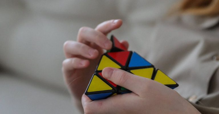 Crop Rotation - Unrecognizable girl twisting combination puzzle at home