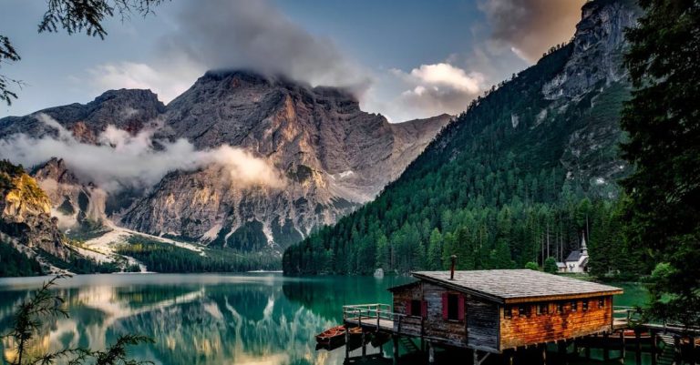 Landscape - Mirror Lake Reflecting Wooden House in Middle of Lake Overlooking Mountain Ranges