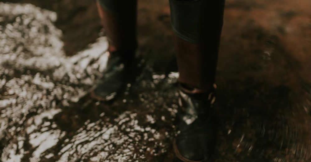 Over-Fertilizing - A person in boots standing in water