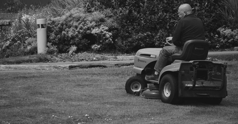 Lawn Mowers - Man Riding a Lawn Mower Vehicle