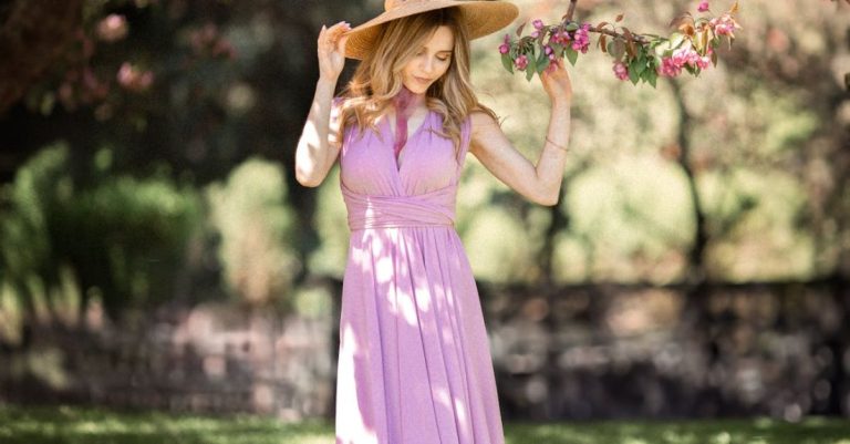 Garden Tiller - A woman in a long purple dress and hat is standing under a tree