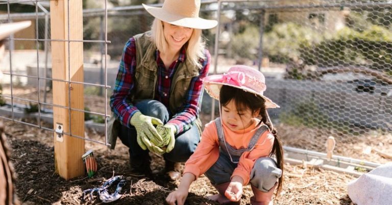Mulching - Woman and a Child Planting Seeds on the Ground