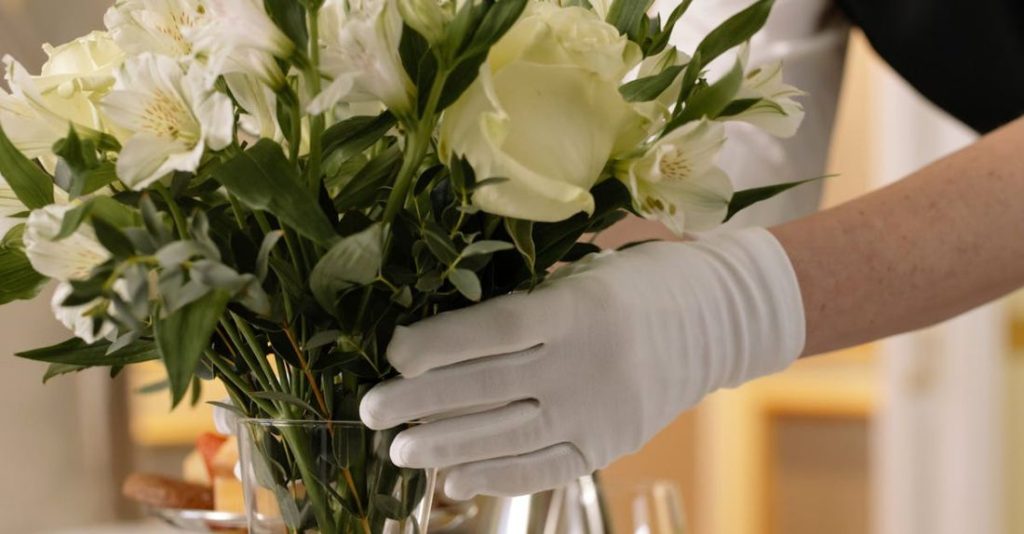 Arranging Flowers - Woman Arranging Flowers in a Glass Vase
