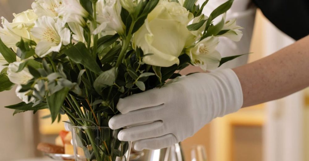 Arranging Flowers - Woman Arranging Flowers in a Glass Vase