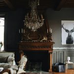 brown-wooden-fireplace-beside-a-gray-fabric-sofa-chair